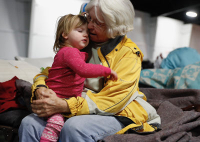 Evacuee Shirley Baker consoles her great-granddaughter Rylee Rhodes at the evacuation center