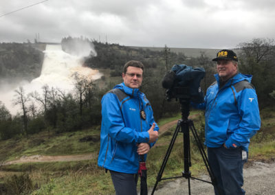Shawn Boyd & John Larimore stand in front of Oroville Dam Spillway