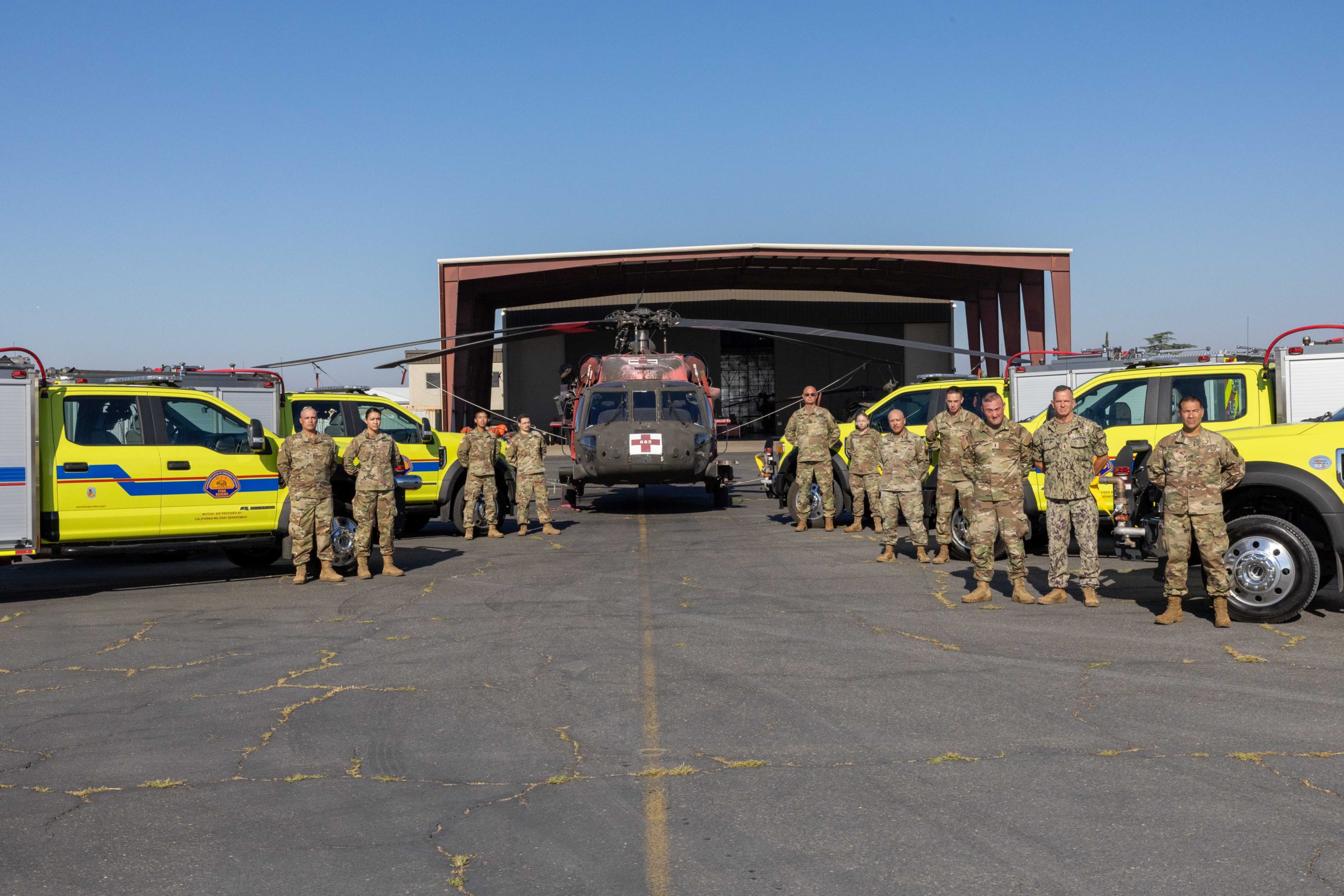 Photo with OES engines and black hawk helicopter and national guardspeople