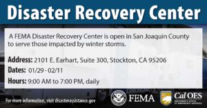 "Disaster Recovery Center" with the address and hours listed in the foreground and an image of FEMA trailers in the background.
