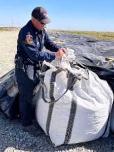 CAL FIRE official unwrapping super sack outside