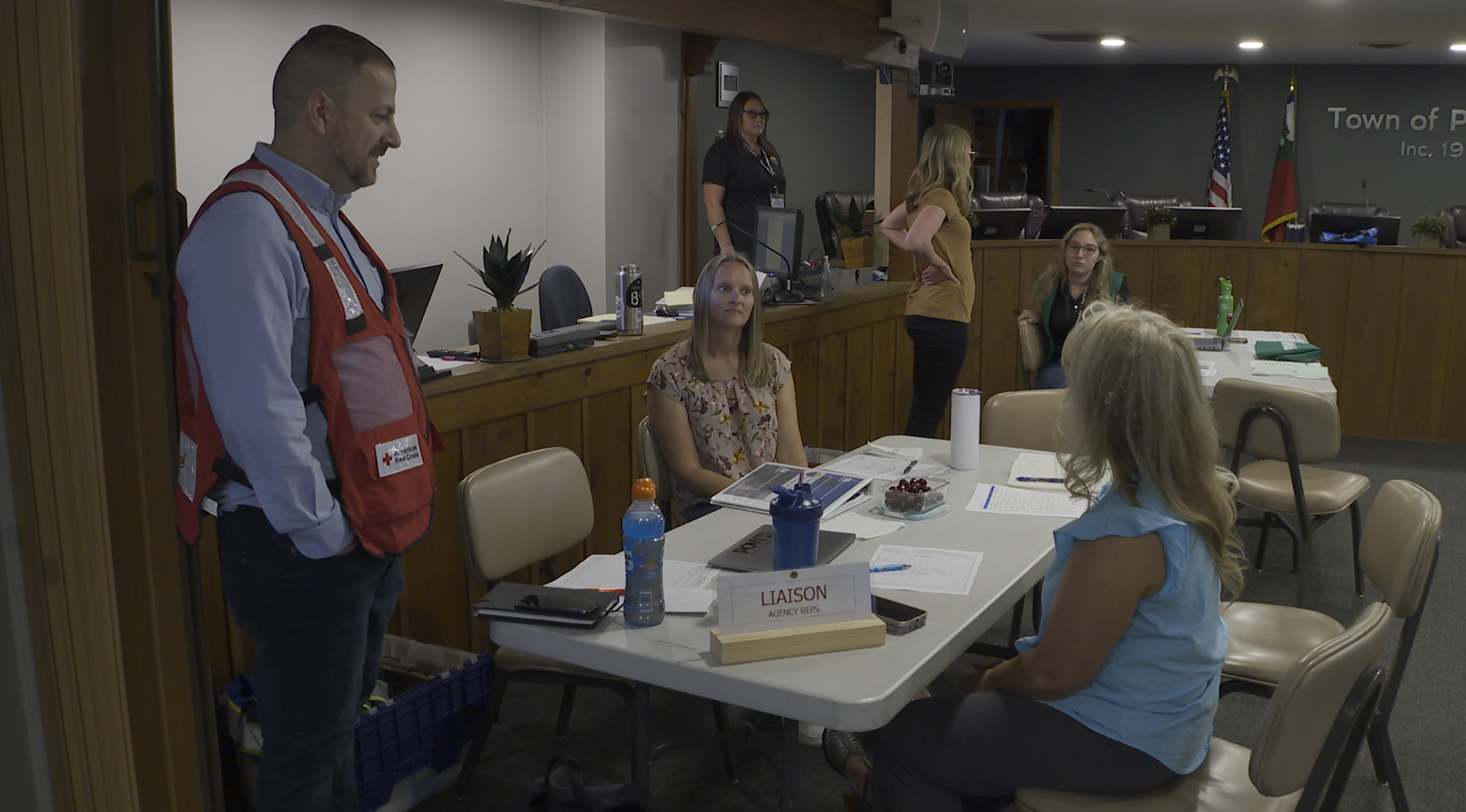 Group of emergency personnel during a simulated emergency exercise within the townhall building in Paradise, California.