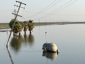 Image of Tulare Lake and propane tank and trees submerged