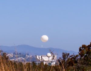A white weather balloon is released from its holding area by the National Weather Service in San Diego