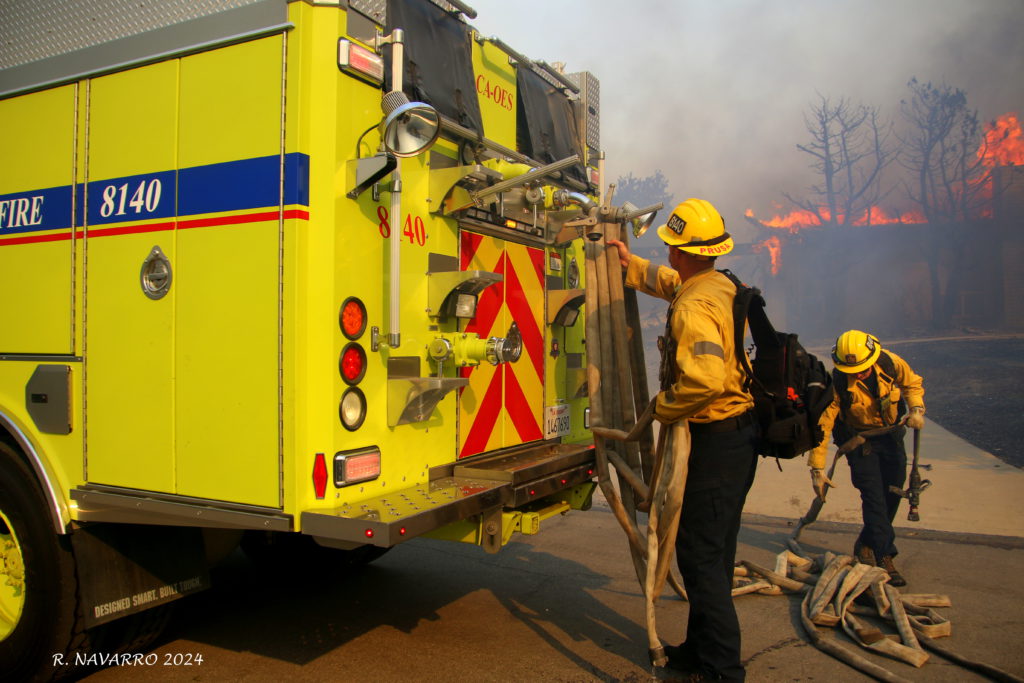 green cal oes fire engine with hose and smoke