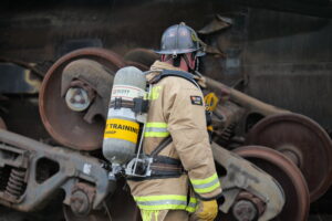 The photo shows a fire fighter participating in a Hazmat Derailment Training at the new Roseville training site.