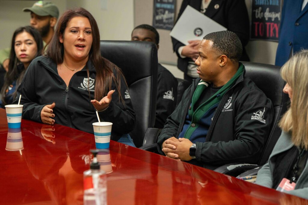 two women speaking at a table