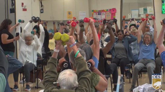 seniors holding hand weights